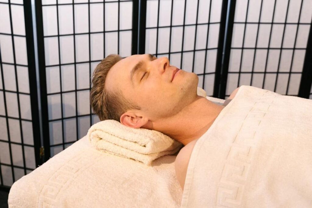 Man resting on a massage table during a professional massage therapy session in Los Angeles.