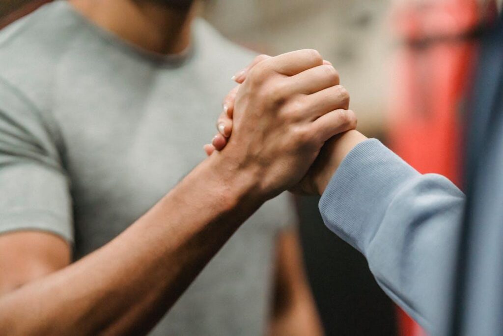 Personal trainer and male client greeting each other at a gym in Palm Springs before a private training session
