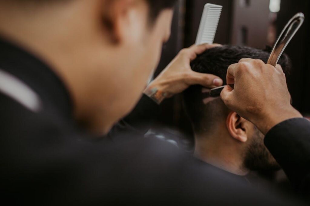Stylist shaping a client’s haircut with careful detailing at a Los Angeles grooming appointment