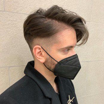 Side profile of a male client with a modern fade haircut in a professional barbershop setting