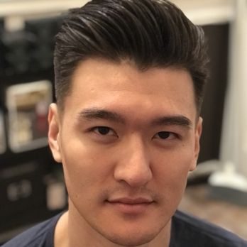 Close-up of a man with neatly styled dark hair and a clean, sharp finish