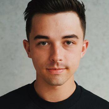 Close-up portrait of a man with a clean haircut and well-groomed appearance